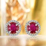 1.25 Carat Round Cut Ruby July Birthstone Halo Stud Earrings in 18K White Gold over Silver