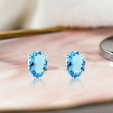 2.5 Carat Oval Cut - Blue Topaz - December Birthstone Solitaire Stud Earrings - 4 Prong - In 18K White Gold Plating Over Silver