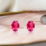 2.5 Carat Oval Cut - Ruby - July Birthstone Solitaire Stud Earrings - 4 Prong - In 18K White Gold Plating Over Silver