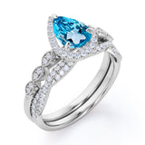 1.5 Carat Pear Cut December Birthstone Blue Topaz and Moissanite Vintage Engagement Ring - Halo Pave Bridal Set in 18K White Gold Over Silver
