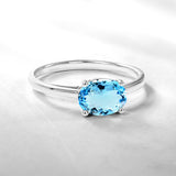 1.25 Carat Oval Cut Blue Topaz SWAROVSKI - December Birthstone Solitaire Engagement Ring in 18k White Gold Over Silver