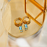 2 Carat Emerald Cut - Blue Topaz - December Birthstone Bezel Huggie Hoop Earrings - 18K Yellow Gold Plating