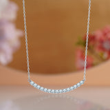 Curved Bar Round-Shaped Moissanite Pendant Necklace in 18K White Gold over Silver