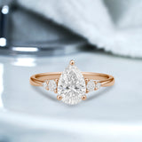 1.10 Ct Pear Moissanite Tapered Side Stone Engagement Ring