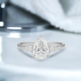 1.10 Ct Pear Moissanite Tapered Side Stone Engagement Ring