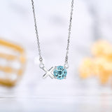 Modern 1.25 TCW Round Cut - Blue Topaz - December Birthstone Floating XO Pendant Necklace in 18K White Gold over Silver