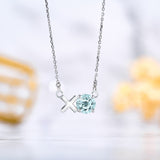 Modern 1.25 TCW Round Cut - Aquamarine - March Birthstone Floating XO Pendant Necklace in 18K White Gold over Silver