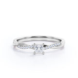 A Refined 0.7 carat Princess Moissanite and Diamond Twisted Shank Engagement Ring in White Gold