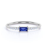 Dainty East West 0.45 Carat Emerald Cut Dark Blue Sapphire and Pave Diamond Engagement Ring in White Gold