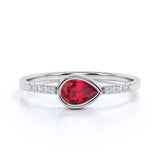 Dainty Bezel 0.75 Carat Pear Lab Ruby and Diamond East West Engagement Ring in White Gold