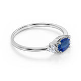 Unique East West 1.40 Carat Oval Cut Dark Blue Sapphire and 7 Stone Diamond Engagement Ring in White Gold