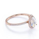 1.50 Carat Pear Shaped Blue Moonstone and Moissanite Halo Engagement Ring in 18k Rose Gold over Silver