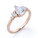 Fashionable 7 Stones 0.6 carat Pear Moissanite and Diamond Engagement Ring in Rose Gold