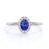 Dainty 0.65 Carat Oval Shape Navy Blue Sapphire and Diamond Halo Classic Engagement Ring in White Gold