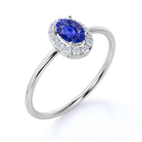 Dainty 0.65 Carat Oval Shape Navy Blue Sapphire and Diamond Halo Classic Engagement Ring in White Gold
