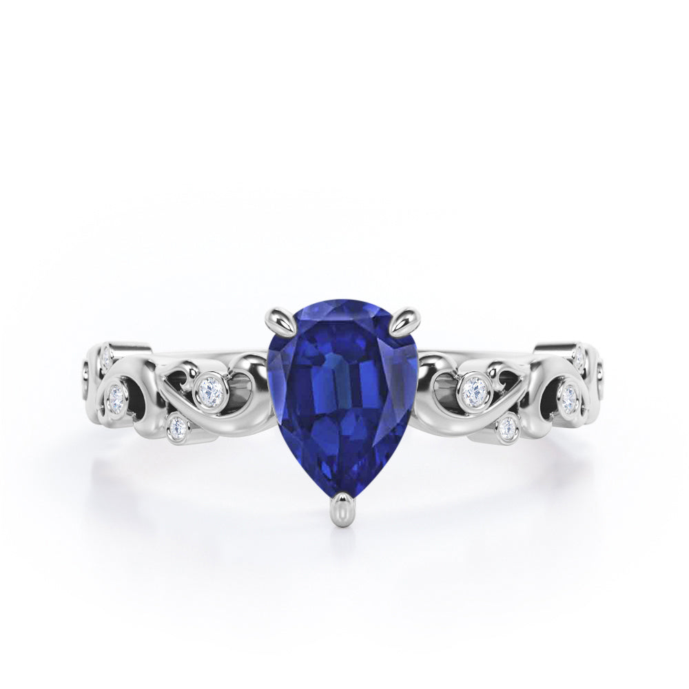 Vintage Style Scroll 0.5 carat Pear Blue Sapphire and Diamond Engagement Ring in Rose Gold