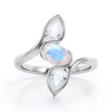 Distorted Line Three Stone 1 carat Oval and Pear Moonstone and moissanite Ring in Rose Gold