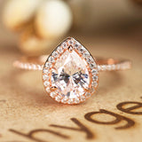 1.50 Carat Pear Cut Moissanite and Diamond Halo Engagement Ring in White Gold