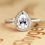 1.50 Carat Pear Cut Moissanite and Diamond Halo Engagement Ring in White Gold