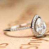 1.50 Carat Pear Cut Moissanite and Diamond Halo Engagement Ring in White Gold