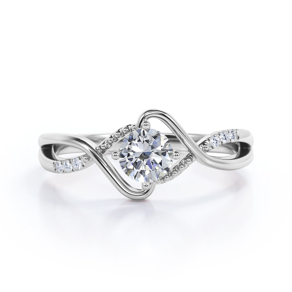 Modern Twisted 0.55 carat Round Moissanite and Diamond Infinity Engagement Ring in Rose Gold