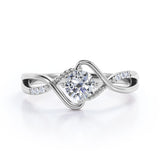 Modern Twisted 0.55 carat Round Moissanite and Diamond Infinity Engagement Ring in Rose Gold