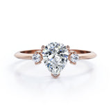 Minimalist Three Stone 0.55 carat Pear Moissanite and Diamond Engagement Ring in Rose Gold