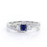 Trellis Three Stones 1 carat Princess Blue Sapphire and Moissanites Braided Engagement Ring in White Gold