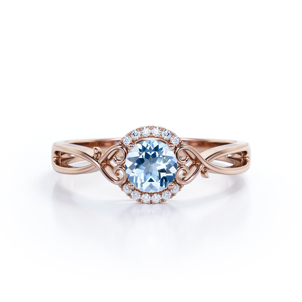 Modern Halo 1.50 Carat Round Cut Vivid Blue Aquamarine and Diamond Heart Twist Engagement Ring