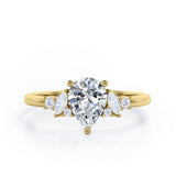 Fashionable 7 Stones 0.6 carat Pear Moissanite and Diamond Engagement Ring in Rose Gold