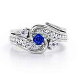 Twisted Tension - Prong 1 TCW Round Brilliant Cut Blue Sapphire and Moissanite - Flush Channel Wedding Set in White Gold