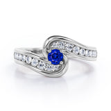 Spinning 0.7 carat Round Blue Sapphire and Moissanite Channel Engagement Ring in White Gold