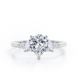 Fashionable 7 Stones 0.6 carat Pear Moissanite and Diamond Engagement Ring in Rose Gold