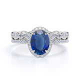 Eternity Micro Pave 2 Carat Oval Cut Sapphire and Diamond Halo Bridal Set in White Gold