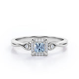 Prong and Halo 0.6 carat Princess Aquamarine and Moissanite Twisted Shank Engagement Ring in White Gold
