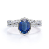 Pave Bezel Set 2 Carat Oval Cut Sapphire and Diamond Infinity Wedding Ring Set with Infinity Band in White Gold