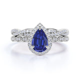 Antique Pave Set 2.25 Carat Pear Cut Sapphire and Diamond Halo Bridal Set with Infinity Band in White Gold