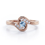 Whirly Gemstone 0.55 carat Round Aquamarine and Moissanites Artistic Engagement Ring in Rose Gold