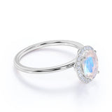 Antique 1.25 Carat Oval Cabochon Cut Blue Moonstone and Diamond Halo Engagement Ring in White Gold