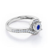 Wrapped Round 0.65 carat Round Blue Sapphire and Moissanites Bypass Engagement Ring in White Gold
