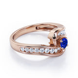 Spinning 0.7 carat Round Blue Sapphire and Moissanite Channel Engagement Ring in White Gold