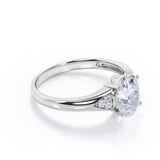 Tapered Shank 7 Stone 1.35 Carat Oval Cut Moissanite and Diamond Prong Basket Engagement Ring in White Gold