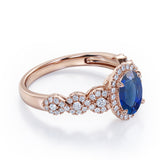 Twisted 1.45 Carat Oval Cut Sapphire And Diamond Halo Engagement Ring In White Gold