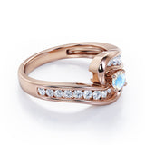 Spinning 0.7 carat Round Moonstone and Moissanite Channel Engagement Ring in Rose Gold