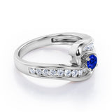 Spinning 0.7 carat Round Blue Sapphire and Moissanite Channel Engagement Ring in White Gold