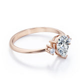 Minimalist Three Stone 0.55 carat Pear Moissanite and Diamond Engagement Ring in Rose Gold