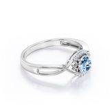 Modern Halo 1.50 Carat Round Cut Vivid Blue Aquamarine and Diamond Heart Twist Engagement Ring