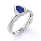 Dazzling Bezel Set 2.25 Carat Pear Cut Sapphire and Diamond Halo Bridal Set with Infinity Band in White Gold