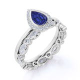 Classic Bezel Set 2.25 Carat Pear Cut Sapphire and Diamond Halo Wedding Set with Art Deco Eternity Band in White Gold
