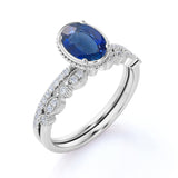 Vintage Bezel Set 1.50 Carat Oval Cut Sapphire and Diamond Art Deco Wedding Ring Set in White Gold